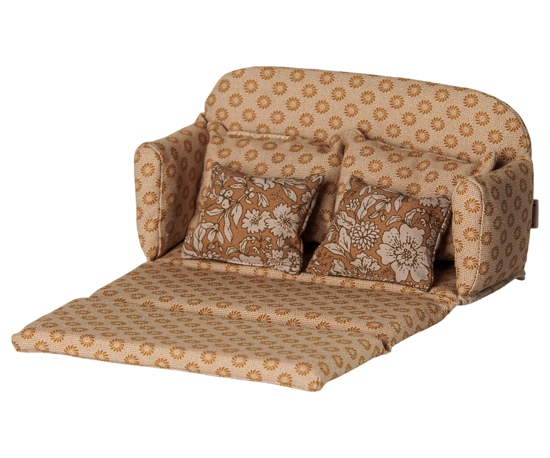 Maileg mouse sofa unfolded into a miniature bed with floral upholstery