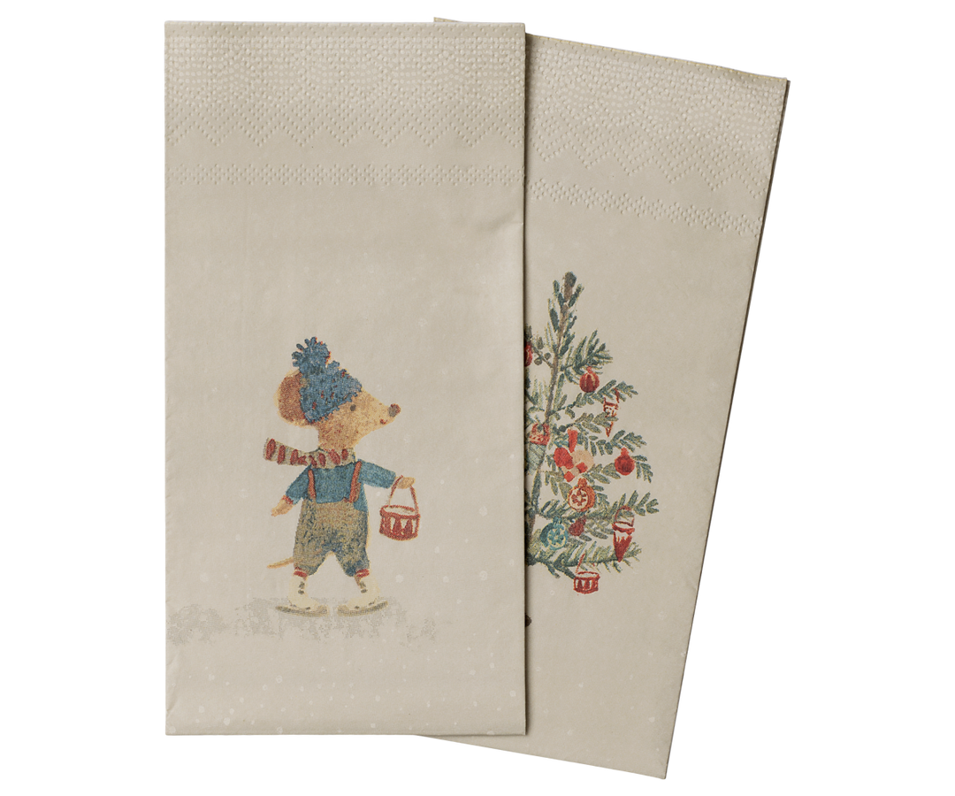 Two beige Maileg paper napkins with a vintage holiday illustration, featuring a mouse in winter clothing and a decorated Christmas tree.