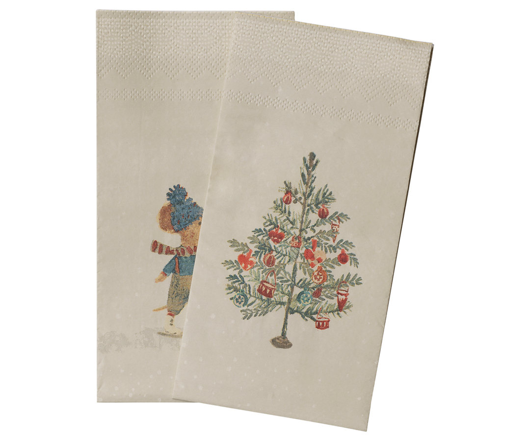 Two beige Maileg paper napkins with a vintage holiday illustration, featuring a mouse in winter clothing and a decorated Christmas tree.